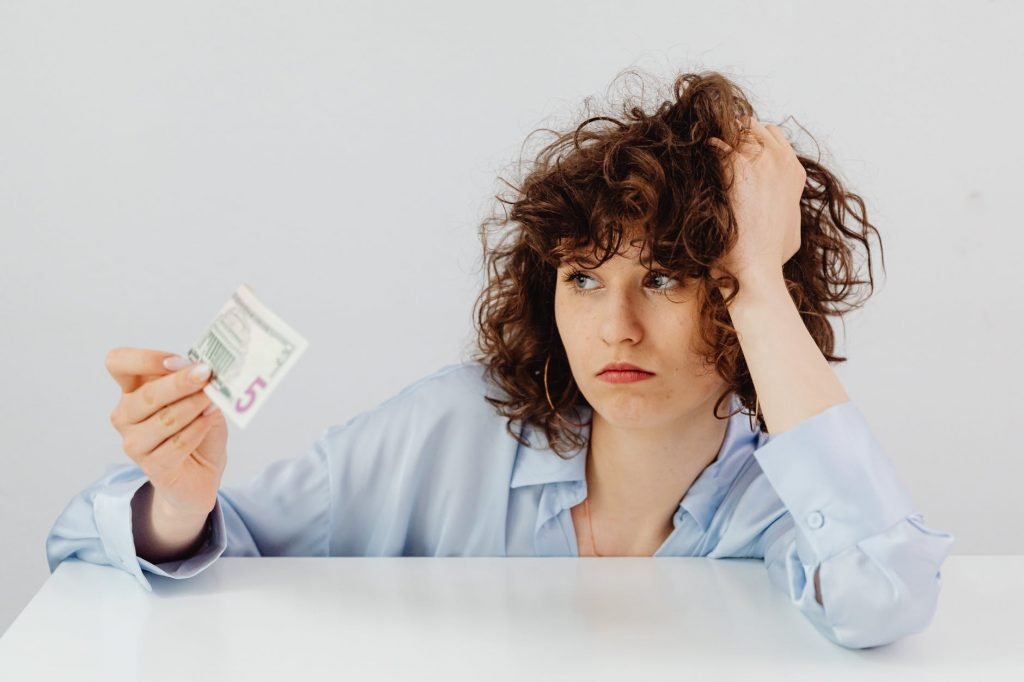woman in white dress shirt holding white ceramic mug