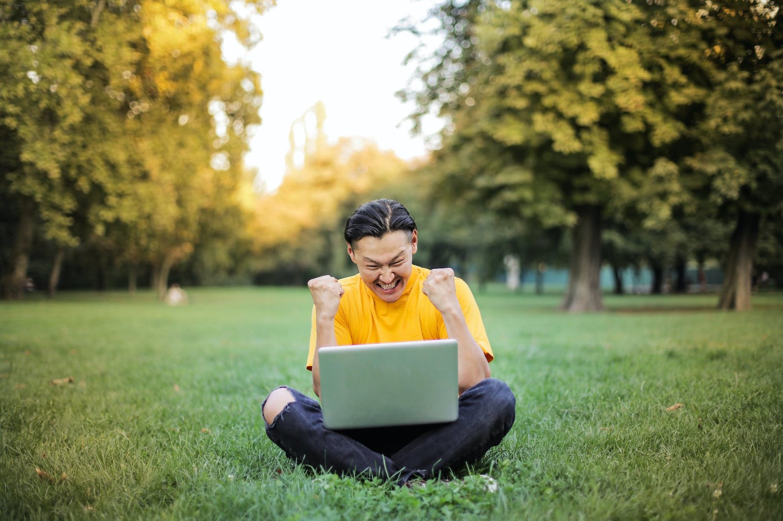 man sitting on a green grass field