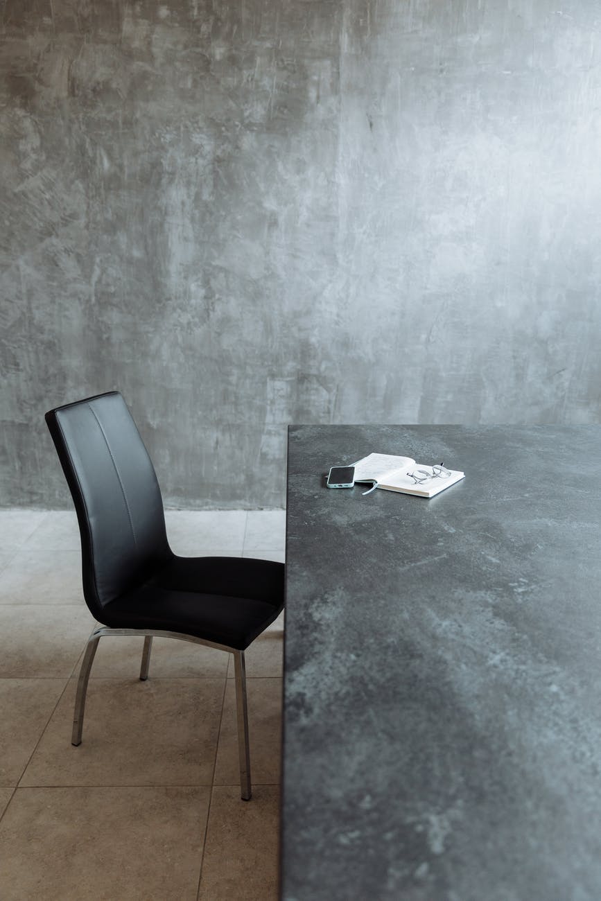 a black chair beside a table